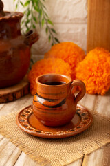 Cafe de Olla, traditional black Mexican coffee, spiced with cinnamon and piloncillo, prepared in a pot and served in a handmade clay cup called a jarrito.
