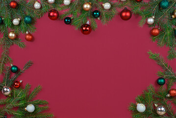 Beautiful and Festive Christmas Ornaments And Pine Decorations Set Against a Red Background