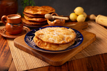 Mexican Buñuelos. Traditionally fried wheat tortillas used for Christmas and winter holidays, these are fried flour tortillas sprinkled with sugar or covered in a syrup made with piloncillo, cinnamon,