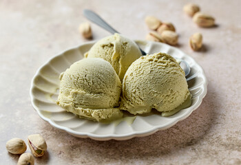 pistachio ice cream scoops on beige plate