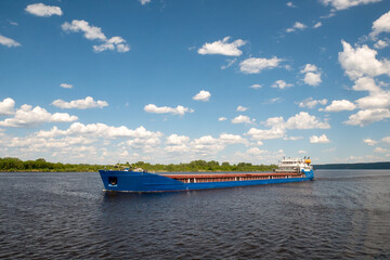 A cargo ship, a cargo ship or an oil tanker, is moving along the river. Logistics and cargo...