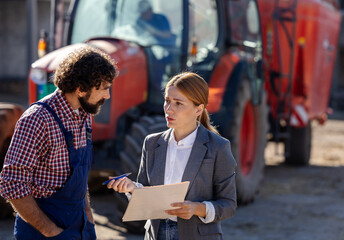 Farm manager consults with business woman about operations on ranch