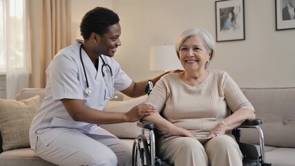 African American healthcare worker in scrubs provides compassionate support to elderly woman in wheelchair, creating a warm and caring environment for patient interaction