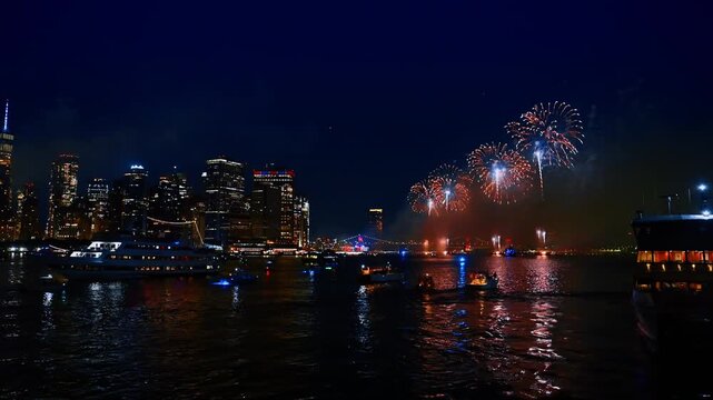 Boat of different size stand on the anchor watching the fireworks above the East River. New York celebrates Independence Day.
