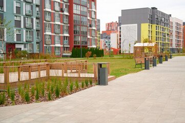 modern apartment buildings and urban park create harmonious living environment. colorful facades,...