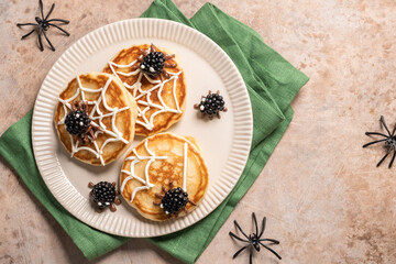 A plate of spider web pancakes with blackberries on top. Halloween food
