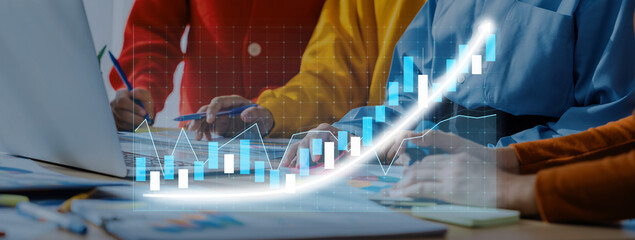 A dynamic business team collaborates on financial analysis, utilizing charts and graphs to visualize data trends, growth potential, and strategic decisions in a modern office. Axiom