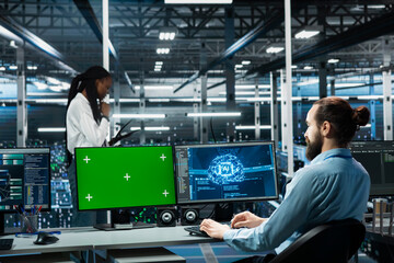 Data center technician monitoring AI systems using green screen mockup PC. Server room IT specialist using chroma key isolated computer, enhancing artificial intelligence performance