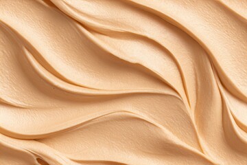 Obraz premium Creamy peanut butter background with wavy texture. Delicious sweet snack cream for spread or cooking dessert ingredient.