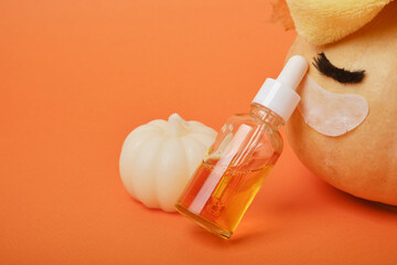 Autumn cute pumpkin with patches and cosmetic containers, autumn self-care concept