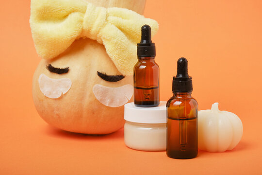 Autumn cute pumpkin with patches and cosmetic containers, autumn self-care concept