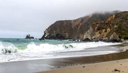 Coastal waves crash against a sandy beach, framed by rugged, misty cliffs.