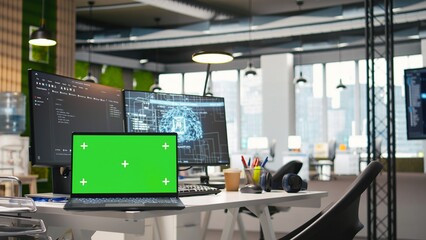 Green screen laptop and AI algorithms running on computer monitors in empty startup workspace deploying machine learning models. Mockup notebook and artificial intelligence coding platform in office