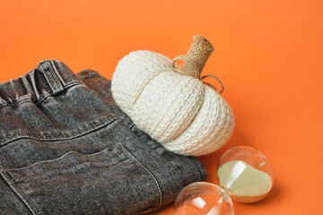 Black jeans, a fabric pumpkin, and an hourglass, the concept of change, fall shopping, and wardrobe updates