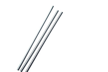 Three slender, parallel, metallic rods against a stark, black background