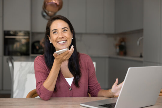 Fototapeta Happy beautiful Latin manager woman talking on cell on speaker