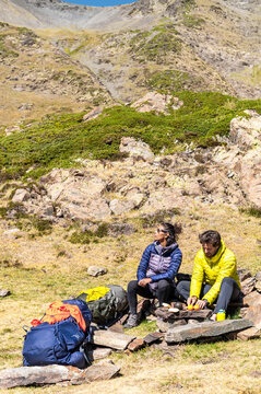 Peaceful travelers enjoying rest in bright mountain valley