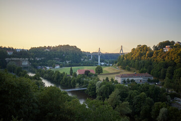 Beautiful sunset over the river valley and bridge in a peaceful rural landscape