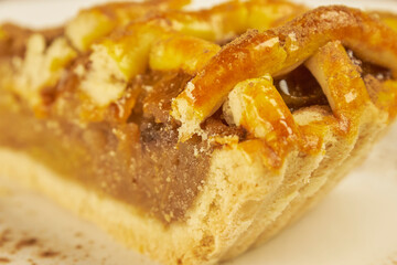Close-up photo of an apple pie on a white background with copy space. Studio photography.
