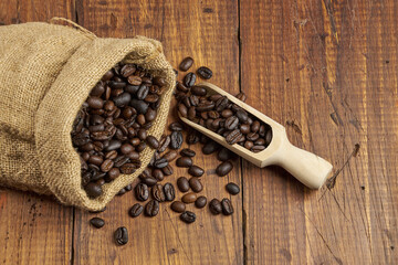 Close-up of coffee beans with copy space on a rustic wooden table, studio shot.