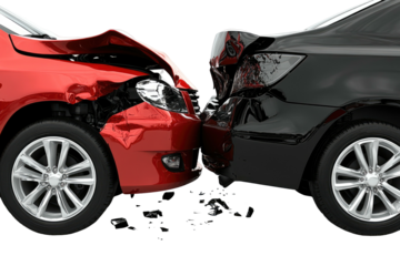 Red car crashes head-on with a black car, intense collision damage