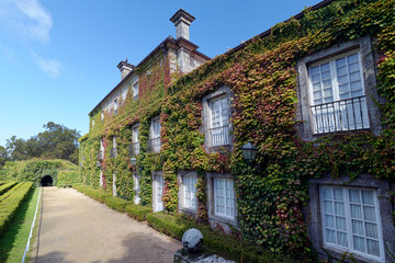 Beautiful manor house covered in greenery at Castrelos Park