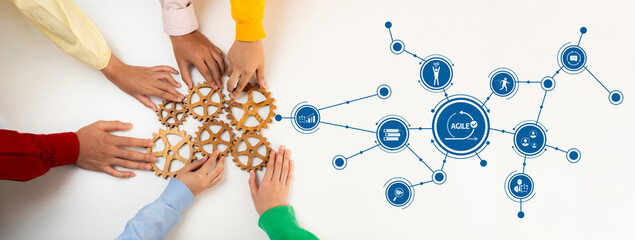 A group of diverse hands work together to connect wooden gears on one side while a digital network symbolizes teamwork and innovation on the other side, showcasing collaboration in action. Amity