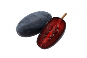Haskap berry, one whole and one sliced showing ripe red flesh and seeds, isolated on a transparent background