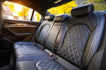 Obraz premium Luxurious black leather car backseat with diamond quilted pattern