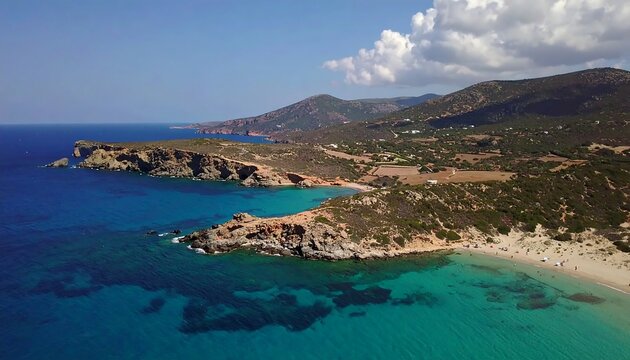 A breathtaking aerial view of a secluded bay, showcasing turquoise waters lapping at rocky shores and lush green hillsides.