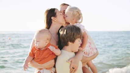 Family enjoys a sunny day by the beach with laughter and love at sunset, creating memories together in the warm sand