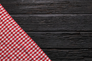 Rustic wooden background with a red-checkered napkin - Space for text and food design