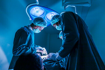 Team of surgeon doctors are performing heart surgery operation for patient from organ donor to save more life in the emergency surgical room
