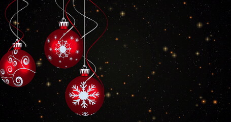 Fototapeta premium Image of yellow stars over christmas baubles