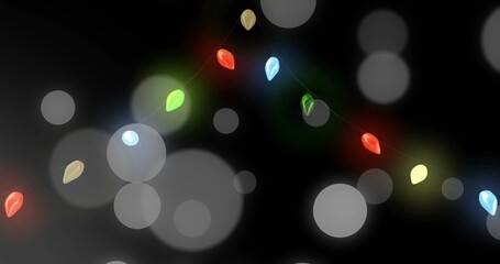 Image of light spots over fairy lights on black background