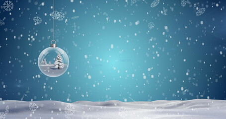 Christmas tree in a hanging bauble decoration and snowflakes falling over winter landscape