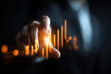 Businessman using futuristic digital interface to analyze glowing financial bar charts with dark background and focus on hand interaction and technology growth trends