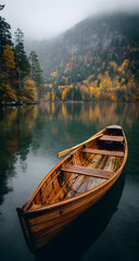 Obraz premium Wooden rowboat floating peacefully on calm water.