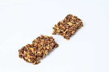 Granola Bar isolated on white background. pile, stack. High protein snack. close up view. clipping path. Broken, half.
