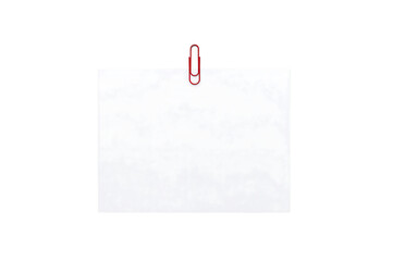 Blank white paper with red paperclip isolated on black background representing memo and message concept