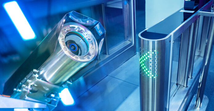Surveillance camera and access control turnstile with green light indicator, concept of security, monitoring and restricted area protection. Security.