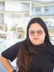 Body positive curvy Asian woman smiling and enjoying casual day.