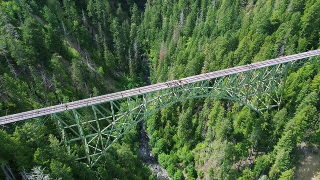Abandoned Vance railroad bridge in western Washington. Flyover shot of the bridge shows the damaged tracks, with the canyon below.