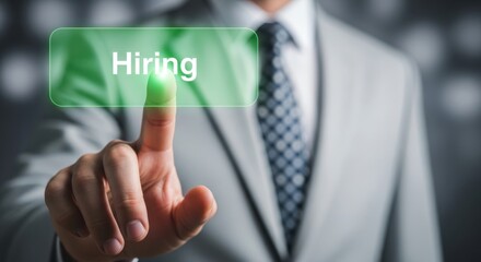 Businessman finger touches glowing green virtual hiring button on digital screen