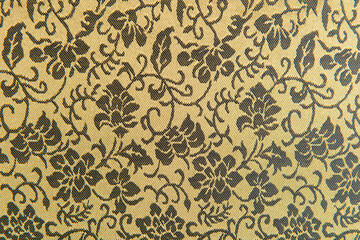 Beautiful texture of paper Wallpaper embossed in form of a classic floral ornament in golden tones.