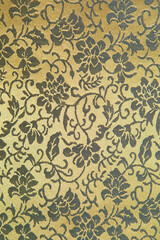 Beautiful texture of paper Wallpaper embossed in form of a classic floral ornament in golden tones.