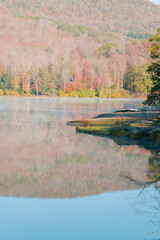 Beautiful Autumn Forest with Mountain Fog and A Lake