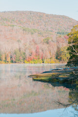 Beautiful Autumn Forest with Mountain Fog and A Lake