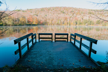 Beautiful Autumn Forest with Mountain Fog and A Lake