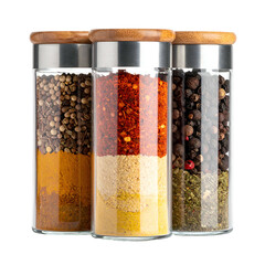 Three glass jars filled with various spices sit on a black background.